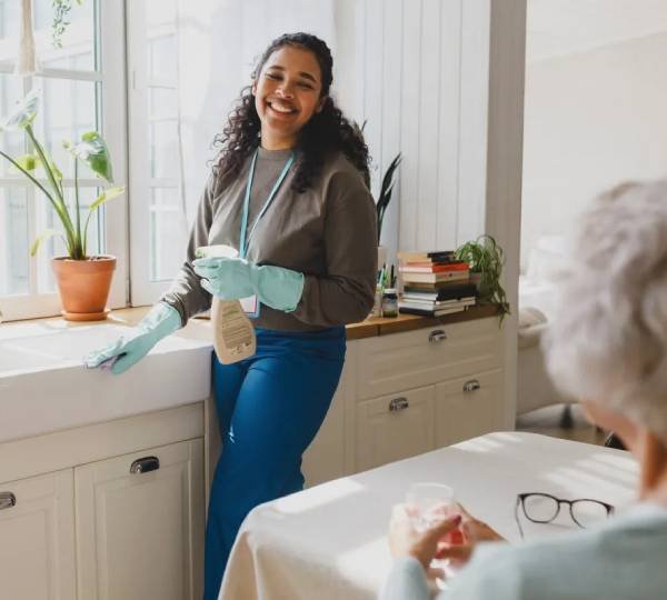 NDIS household task support worker cleaning a home